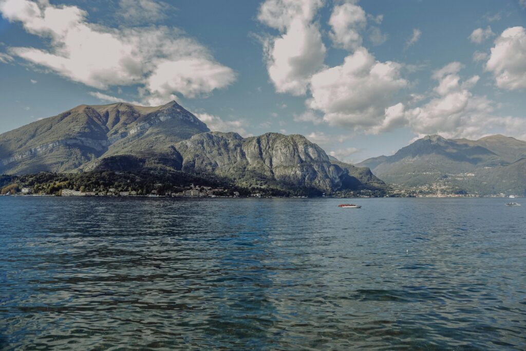 Scenic view of Lake Como, Italy, featuring serene blue waters surrounded by lush mountains, with charming villas nestled along the shoreline, perfect for romantic getaways for couples seeking tranquility and breathtaking landscapes.