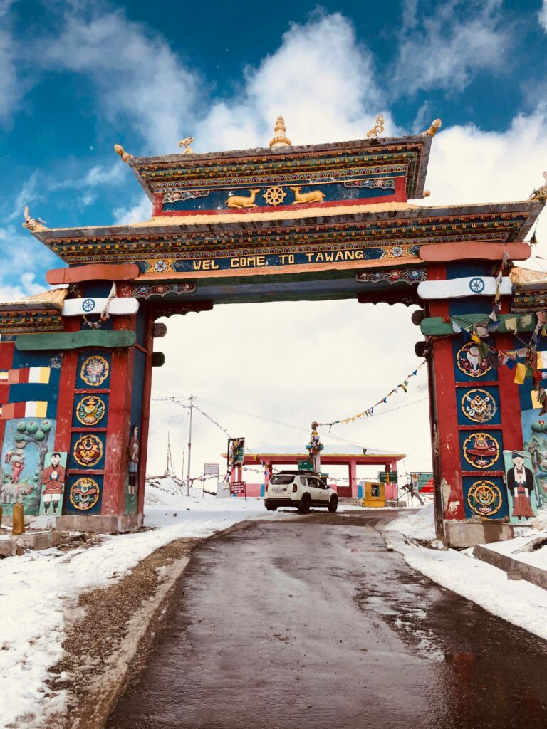 Historic gate of Tawang in winter, India, framed by snow-capped mountains and a clear sky, representing one of the top winter tourist destinations in India with its serene and picturesque landscape.