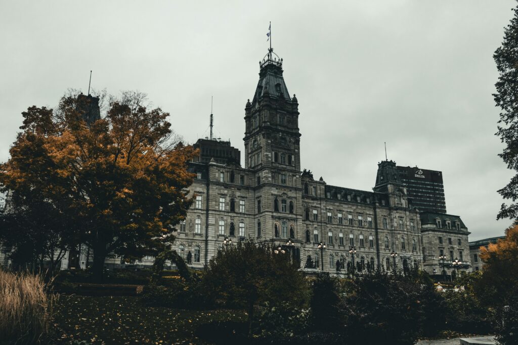 Charming historic building in Quebec City, Canada, with picturesque architecture, perfect for romantic getaways for couples. The scene captures the essence of a cozy and intimate escape in a beautiful, old-world setting.